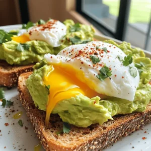 - 2 ripe avocados - 4 slices of whole grain bread - 4 large eggs - 1 tablespoon fresh lemon juice - Salt and pepper to taste - Optional: red pepper flakes for heat - Fresh herbs for garnish To make avocado toast with poached egg, gather these fresh ingredients. Start with ripe avocados. They should feel slightly soft but not mushy. Whole grain bread gives a nice texture and is healthy, too. Eggs are key to this dish; use large eggs for a satisfying poach. Lemon juice adds brightness to the avocado spread. Salt and pepper enhance the flavors, while red pepper flakes can add a bit of heat if you like. Finally, fresh herbs make your dish look and taste wonderful. You can choose cilantro, chives, or parsley, depending on your preference. Check out the Full Recipe to see how these simple ingredients transform into a tasty meal! Start by toasting the whole grain bread. You can use a toaster for quick results. Alternatively, heat a dry skillet over medium heat and add the bread slices. Toast until they turn golden brown and crispy. This gives your toast the perfect base. While the bread toasts, grab your ripe avocados. Cut them in half and scoop the flesh into a bowl. Use a fork to mash the avocado; it should be creamy but still a bit chunky. Stir in fresh lemon juice and a pinch of salt and pepper. This adds flavor and keeps the avocado bright. Fill a medium saucepan with about 3 inches of water. Bring it to a gentle simmer. Crack each egg into a small bowl first. This helps keep them intact. Gently slide each egg into the water, one by one. Poach them for about 3-4 minutes. If you want firmer yolks, cook them a bit longer. Once the bread is toasted, take a slice and spread a generous layer of the avocado mix on top. Place a poached egg carefully on each slice. Make sure the yolk stays intact for that delightful runny experience. This layering creates both flavor and visual appeal. For a little extra heat, sprinkle some red pepper flakes over the poached eggs. This is optional, but it adds a nice kick. Finish by adding fresh herbs like chopped cilantro or chives. They provide a pop of color and freshness. Serve your toast right away to enjoy the great mix of textures and flavors. For the full recipe, check out the instructions above. To poach eggs well, start with fresh eggs. Fresh eggs hold their shape better. A common mistake is using water that boils too hard. This can break the eggs. Instead, let the water simmer gently. Add a splash of vinegar to help the egg whites stay together. If you want tools, consider using a poaching pod or a small mesh strainer. These tools make it easier to transfer eggs into the water. When picking avocados, look for ones that yield slightly to gentle pressure. This means they are ripe and ready. Avoid avocados with dark spots or large dents. The best varieties for flavor are Hass and Bacon. Hass avocados have a creamy texture and rich taste, while Bacon avocados are milder and lighter. Both make your toast tasty and delightful. You can toast bread in many ways. Use a toaster, skillet, or even an oven. For a crunchy texture, try broiling the bread for a short time. Keep an eye on it to avoid burning. To enhance your toast, add toppings like cheese, herbs, or spices. A sprinkle of garlic powder or a slice of mozzarella can elevate the flavor. Try different combinations to find your favorite! {{image_4}} You can add fun toppings for more flavor. Try sliced tomatoes or radishes for crunch. Smoked salmon gives a nice salty taste. Cheese options are also great. Feta or goat cheese can add creaminess and tang. The bread you choose changes the taste and feel. Whole grain gives a nutty flavor. Sourdough adds a bit of tang. For gluten-free eaters, use gluten-free bread. Each type adds its own special touch. Spices can make your toast even better. Cumin adds warmth, while paprika gives a slight kick. Fresh herbs like basil or dill can brighten the dish. Experimenting with these can enhance your avocado toast experience. Want to learn more? Check the Full Recipe for more ideas! To keep your leftover avocado fresh, use these tips. First, cover the avocado tightly with plastic wrap. Press the wrap directly onto the flesh to limit air exposure. You can also store it in an airtight container. Adding lemon juice can help slow down browning. If you have half an avocado, use it within one day for the best taste. For longer storage, consider freezing avocado. Cut it into chunks and toss it with lemon juice. Place the pieces in a freezer bag. They will last up to six months. Just remember, frozen avocado is best used in smoothies or spreads. Once you've cooked your poached eggs, store them in the fridge. They can last for about two days. Place them in a container with a lid to keep them fresh. When you are ready to eat them, gently reheat them in warm water to avoid overcooking. You can also use the eggs in salads or sandwiches. For the avocado spread, store it in the fridge as well. It can last about three days. If you notice browning, simply stir it before use. You can also use it as a dip for chips or veggies. This way, you can enjoy your delicious leftovers in various ways! To keep your poached eggs intact, follow these tips: - Use fresh eggs. Fresh eggs hold their shape better. - Crack each egg into a small bowl first. This helps you control the drop. - Create a gentle whirlpool in the water. Stir the water with a spoon before adding the egg. - Poach in simmering, not boiling, water. This helps prevent the eggs from breaking. These steps lead to beautiful poached eggs every time. Yes, you can prep some parts ahead of time! Here’s how: - Toast the bread just before serving for crispness. - Mash the avocado but add lemon juice to slow browning. - Store the avocado mix in an airtight container. Press plastic wrap on the surface to keep it fresh. - Poach the eggs right before serving for the best texture. Prepping ahead saves time, but fresh is always best! If you love avocado toast, try these dishes: - Hummus toast with sliced veggies. - Nut butter toast with banana slices. - Smoked salmon on cream cheese toast. - Ricotta with honey and figs on bread. These options are tasty and easy to make! Yes, avocado toast is a healthy choice! Here’s why: - Avocados are rich in healthy fats. They help your heart and keep you full. - Eggs provide protein, which is great for muscle health. - Whole grain bread offers fiber, good for digestion. - Adding fresh herbs boosts vitamins and flavor. This meal is a great way to start your day! For the full recipe, check out [Full Recipe]. This blog post explored the steps to make delicious avocado toast. We covered the key ingredients, from ripe avocados to perfectly poached eggs. You learned how to toast bread, prepare avocado spread, and assemble your dish. Keep these tips in mind. Experiment with toppings and seasoning. Try different breads for new flavors. With a little practice, you’ll create a tasty, healthy meal. Enjoy your avocado toast creations and share them with others!