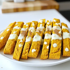 - 2 cups all-purpose flour - 1 cup white chocolate chips - 1/2 cup pure pumpkin puree - 2 large eggs - 1 teaspoon ground cinnamon - 1/2 teaspoon ground nutmeg - 1/2 teaspoon ground ginger - 1/4 teaspoon ground cloves - 1/2 teaspoon salt - 1/2 cup granulated sugar - 1/4 cup brown sugar, packed - 1/2 cup chopped walnuts or pecans The main ingredients create the base for this tasty biscotti. The all-purpose flour gives structure. White chocolate chips add sweet creaminess. Pumpkin puree brings moisture and flavor. The eggs act as a binding agent to hold everything together. Next, we add spices to make it special. Ground cinnamon warms the palate. Nutmeg adds a nutty, sweet flavor. Ginger brings a hint of spice, while cloves add depth. Salt balances all the sweet flavors. For sweetness, we use granulated sugar and brown sugar. Granulated sugar gives a clean sweetness. Brown sugar adds a slight caramel touch. Optional add-ins like walnuts or pecans can enhance texture. They add crunch and flavor, making each bite delightful. You can mix and match ingredients based on your taste. Enjoy creating your perfect pumpkin spice biscotti! - Preheat oven to 350°F (175°C). - Line baking sheet with parchment paper. - In a bowl, whisk together: - 2 cups all-purpose flour - 1 teaspoon baking powder - 1/2 teaspoon baking soda - 1 teaspoon ground cinnamon - 1/2 teaspoon ground nutmeg - 1/2 teaspoon ground ginger - 1/4 teaspoon ground cloves - 1/2 teaspoon salt Setting this bowl aside lets the spices blend well. - In a large bowl, mix: - 1/2 cup granulated sugar - 1/4 cup brown sugar - 2 large eggs - Beat this mixture until it looks light and smooth. - Add: - 1/2 cup pure pumpkin puree - 1 teaspoon vanilla extract - Mix until everything combines well. - Gradually fold the dry mixture into the wet mixture. - Be gentle to avoid overmixing. - If you want, fold in: - 1/2 cup chopped walnuts or pecans - 1 cup white chocolate chips This adds a nice texture and flavor. - Divide the dough into two equal parts. - Shape each part into logs, about 12 inches long and 3 inches wide. - Place the logs on your prepared baking sheet with space between them. - Bake for 25-30 minutes, until they feel firm and look golden. - Remove the logs from the oven and let them cool on the sheet for 10 minutes. - Transfer to a cutting board and slice diagonally into 1/2-inch thick pieces. - Return the slices to the baking sheet, cut-side up. - Bake for another 10-15 minutes until they are crisp and golden. - After the second bake, let them cool completely on a wire rack. For a special touch, melt some more white chocolate and drizzle it over the cooled biscotti. Enjoy! To get light and crispy biscotti, avoid overmixing the dough. Overmixing adds too much air, making the biscotti dense. Here are some tips for the right consistency: - Mix wet ingredients until smooth. - Fold in dry ingredients gently. - If using nuts or chocolate, mix them in last. Melting white chocolate can be tricky. Here are the best methods to do it right: - Use a microwave-safe bowl. Heat in short bursts of 20 seconds. - Stir after each burst to prevent burning. - Alternatively, use a double boiler for even melting. For drizzling, follow these steps for an elegant touch: - Use a fork or a piping bag to drizzle the chocolate. - Move your hand in a back-and-forth motion over the biscotti. - Let the chocolate set before serving. A beautiful presentation makes your biscotti stand out. Here are some creative ideas: - Arrange biscotti in a glass jar for a cozy look. - Serve on a colorful platter to catch the eye. - Pair with a hot cup of coffee or tea for a delightful treat. Feel free to experiment with different settings to showcase these tasty delights! {{image_4}} You can easily change the taste of your biscotti. Adding dried fruits like cranberries or apricots brings a sweet twist. Chocolate chips, dark or milk, also add richness. Nuts like almonds or hazelnuts give a great crunch. Each choice makes your biscotti unique. You might want to adjust the flavors based on the season. Try adding peppermint for winter or citrus zest for spring. For a holiday touch, mix in some festive spices like cardamom or allspice. These changes help you celebrate the season with every bite. If you need a gluten-free biscotti, start with gluten-free flour blends. Almond flour works well too, but you may need to add more binding agents. Using xanthan gum can help maintain the perfect texture. With these swaps, your biscotti will still taste amazing. To keep your pumpkin spice biscotti fresh, use an airtight container. This helps avoid moisture, which makes them soft. A glass jar or plastic container works great. Store them at room temperature in a cool, dry place. You can also place a piece of parchment paper between layers to avoid sticking. To freeze your biscotti, follow these steps: 1. Cool Completely: Let the biscotti cool down on a wire rack. 2. Slice: If not sliced, cut them into the classic biscotti shape. 3. Wrap: Wrap each biscotti in plastic wrap or aluminum foil. 4. Bag: Place wrapped biscotti in a freezer-safe bag. Remove as much air as possible. 5. Label: Write the date on the bag for reference. When you're ready to enjoy, thaw them in the fridge or at room temperature. For the best texture, toast them in the oven for a few minutes after thawing. These tasty biscotti will last about 1 to 2 weeks at room temperature. If you store them in the fridge, they can last up to 3 weeks. Always check for any signs of spoilage before enjoying them. Serve your pumpkin spice biscotti with coffee or tea. The warm drinks bring out the flavors. I love to dip the biscotti into my coffee. The crunch of the biscotti and the warmth of the drink blend perfectly. You can also pair it with a spiced chai. It adds a nice touch to your snack time! Yes, you can make these biscotti ahead of time. Prepare them a day or two in advance. Allow them to cool completely before storing. Place them in an airtight container to keep them fresh. They will taste just as good when you are ready to enjoy them! You can use other ingredients in place of pumpkin puree. For instance, you can try using sweet potato puree. It gives a similar texture and flavor. Applesauce is another option, but it may change the taste slightly. Each substitute adds its own twist to the biscotti. To check if your biscotti are done, look for a light golden color. They should feel firm to the touch. When you slice them, they should be crisp but not hard. Let them bake until they are just right for that perfect bite! If you don’t have white chocolate, you can use milk chocolate or dark chocolate. Both options will add a rich flavor to your biscotti. You can also skip the chocolate drizzle altogether. A simple dusting of powdered sugar can work well too! This post shared a simple way to make pumpkin spice biscotti. We discussed the key ingredients, from flour to spices. I guided you through each step, ensuring you know how to get the right texture. The tips covered how to store, freeze, and serve these tasty treats. Now, you can whip up these delightful cookies yourself. Enjoy them fresh, or share them with friends. Happy baking, and may your biscotti be crisp and delicious!