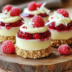To make these no-bake white chocolate raspberry cups, gather these simple ingredients: - 1 cup white chocolate chips - 1/4 cup coconut oil - 1/2 cup fresh raspberries (plus extra for garnish) - 1/2 cup crushed digestive biscuits or graham crackers - 1 tablespoon powdered sugar - 1 teaspoon vanilla extract - Pinch of salt - White chocolate shavings (for garnish) Each ingredient plays a key role. The white chocolate chips provide sweetness and creaminess. Coconut oil gives a smooth texture. Fresh raspberries add a tart contrast. Crushed biscuits form the crunchy base. Powdered sugar sweetens and blends well. Vanilla extract enhances flavor. A pinch of salt balances the sweetness. You can swap some ingredients if needed. Here are a few ideas: - White chocolate chips: Use milk chocolate or dark chocolate chips for a different taste. - Coconut oil: Substitute with butter or vegetable oil for a similar texture. - Fresh raspberries: Strawberries, blueberries, or cherries can work well too. - Digestive biscuits: Graham crackers, Oreos, or any favorite cookie can be used. These swaps help fit your taste and what you have at home. Choosing the best raspberries is key for flavor. Here’s how to find the freshest ones: - Look for bright color: Ripe raspberries are deep red and shiny. - Check for firmness: They should feel plump and firm, not mushy. - Inspect for mold: Avoid containers with mold or squished berries. - Smell: Fresh raspberries have a sweet, fruity smell. Using fresh, high-quality raspberries elevates your treats. Enjoy the burst of flavor they bring! Start by lining a muffin tin with cupcake liners or silicone molds. This makes it easy to pop the treats out later. Ensure each liner is secure and ready for filling. This step is key for a neat presentation. In a microwave-safe bowl, add the white chocolate chips and coconut oil. Microwave this mix in 30-second bursts. Stir it well after each time. Keep going until the chocolate is smooth and shiny. This will give your cups a rich flavor and perfect texture. Once your chocolate is melted, stir in the powdered sugar, vanilla extract, and a pinch of salt. Mix it well until everything is blended. This step enhances the chocolate's taste and adds depth to your cups. Begin by scooping about 1 tablespoon of the melted chocolate mixture into each lined cup. This forms your base layer. Next, place a few fresh raspberries on top. Then, take your biscuit mix and add a spoonful over the raspberries. Press it down gently to make a firm layer. Pour another layer of melted white chocolate over the biscuit mix. Ensure it covers the raspberries completely. Keep layering until the cups are full. Place the muffin tin in the fridge for at least 2 hours. This step is vital for the chocolate to set. Once they are firm, gently take the cups out of their molds. For a nice touch, add more fresh raspberries and sprinkle white chocolate shavings on top. Enjoy these chilled for a refreshing treat! When making no-bake white chocolate raspberry cups, avoid these common mistakes: - Not using fresh raspberries: Old raspberries can ruin the taste. - Overheating the chocolate: This can make it grainy. - Not chilling long enough: Cups need time to set. To melt your chocolate smoothly, follow these tips: - Use low power: Microwave in 30-second bursts. - Stir often: This helps the chocolate melt evenly. - Add coconut oil: This keeps the chocolate smooth and shiny. Give your cups a twist with these ideas: - Top with whipped cream: This adds extra creaminess. - Use different fruits: Strawberries or blueberries also work well. - Serve with ice cream: This makes a fun dessert combo. {{image_4}} You can swap raspberries for other fruits. Strawberries, blueberries, or blackberries work great. Each fruit brings its own taste. Strawberries add sweetness. Blueberries bring a nice tartness. Blackberries offer a bold flavor. Simply layer the fruit as you would with raspberries. This keeps your cups fresh and exciting. While this recipe uses white chocolate, you can try others too. Dark chocolate gives a rich taste. Milk chocolate offers a creamier flavor. You can even blend chocolates for a unique twist. Remember to adjust any sweeteners if you use dark chocolate. Each type will change the cups’ flavor profile. To make these cups gluten-free, choose suitable biscuits. Look for gluten-free digestive biscuits or graham crackers. You can also use crushed nuts for a crunchy base. Just mix them with the melted chocolate like the original recipe. This way, everyone can enjoy these tasty treats without worry. To store leftover cups, place them in an airtight container. This keeps them fresh and tasty. Line the container with parchment paper for extra care. Make sure the cups do not touch each other to avoid sticking. If you want to freeze your cups, wrap each one in plastic wrap. Then, place them in a freezer-safe bag. This stops freezer burn and keeps the flavor. When ready to eat, let them thaw in the fridge overnight. These no-bake cups can last about five days in the fridge. After that, they may lose taste and texture. If frozen, they can stay good for up to three months. Always check for any changes in smell or look before eating. Yes, you can use dark chocolate. It will change the flavor. Dark chocolate adds a rich taste. It pairs well with raspberries. The sweetness of the raspberries will balance the dark chocolate. Just remember that it will not be as sweet. Store them in the fridge for up to five days. Keep them in an airtight container. This helps keep them fresh and tasty. If you want to enjoy them later, check for any signs of spoilage. The chocolate may lose some creaminess over time. You can use many fruits! Strawberries, blueberries, or even bananas work well. Each fruit gives a unique flavor. Try mixing different fruits for fun. Just make sure they are fresh and ripe for the best taste. This blog post covered everything you need to make delicious raspberry chocolate cups. You learned about key ingredients and how to choose fresh raspberries. I provided clear steps for preparation and tips to avoid common mistakes. Variations offered fun ideas for personal touches, and I outlined how to store leftovers properly. Remember, experimenting makes cooking fun. Enjoy making these treats your way!
