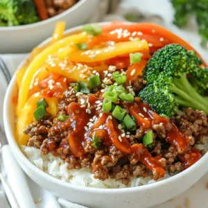 - 1 lb ground beef - 3 tablespoons gochujang - 2 tablespoons soy sauce - 1 tablespoon sesame oil - 1 tablespoon brown sugar - 2 cloves garlic - 1 teaspoon fresh ginger - 2 cups broccoli florets - 1 medium carrot - 1 bell pepper - 4 green onions - Sesame seeds for garnish - 2 cups cooked rice (white or brown) - Alternative grains for serving In this recipe, the combination of flavors is key. The main ingredient is ground beef, which brings rich taste and texture. Gochujang, a spicy Korean chili paste, adds heat and depth. Soy sauce gives a savory element, while sesame oil and brown sugar balance the flavors perfectly. Fresh produce adds color and nutrition. Garlic and ginger boost flavor. Broccoli, carrots, and bell peppers provide crunch and sweetness. Green onions and sesame seeds enhance the dish with fresh notes. For the base, use cooked rice or try alternative grains like quinoa or cauliflower rice. This choice can change the dish's vibe entirely. {{ingredient_image_2}} 1. Heat a large skillet over medium-high heat. 2. Add the ground beef and break it apart with a spatula. 3. Cook until the beef is fully browned, about 5-7 minutes. 4. Drain any excess fat from the skillet. 1. Lower the heat to medium. 2. Add gochujang, soy sauce, sesame oil, brown sugar, minced garlic, and grated ginger. 3. Stir well to coat the beef evenly. 4. Let the mixture simmer for 2-3 minutes, stirring occasionally. 1. In a separate pot or steamer, cook the broccoli, julienned carrots, and sliced bell pepper. 2. Steam for about 3-5 minutes until just tender. 3. Alternatively, sauté the veggies in sesame oil for more flavor. 1. Start with a scoop of cooked rice at the bottom of each bowl. 2. Add a hearty portion of the spicy beef mixture. 3. Top with a colorful array of the sautéed or steamed vegetables. 4. Make sure to arrange the ingredients nicely for a great look. 1. Garnish with chopped green onions and sesame seeds. 2. This adds a nice crunch and extra flavor. 3. Serve the bowls hot and enjoy with chopsticks for fun! - Best practices for browning beef: Use a large skillet and set it on medium-high heat. This helps the beef cook evenly. Break it apart with a spatula as it cooks. This keeps it from clumping together. You want it nicely browned, which takes about 5-7 minutes. If there's extra fat, drain it for a leaner dish. - Flavor enhancement tips for gochujang: Gochujang is rich and spicy. To make it shine, mix it well with soy sauce, sesame oil, and brown sugar. This blend creates a sweet and spicy balance. Let the beef simmer for a few minutes to soak up all the flavors. - Ideal side dishes: This dish pairs well with simple sides. Try steamed rice or a fresh salad. You can also serve it with kimchi for a traditional touch. The tangy taste of kimchi complements the spicy beef. - Drink pairings to complement the meal: Enjoy this meal with a cold beer or sweet tea. If you prefer non-alcoholic drinks, try sparkling water with lime. These drinks balance the heat and enhance the flavors. - Arranging ingredients for visual impact: When you serve, layer the rice, beef, and veggies in bowls. This makes each bowl colorful and inviting. Use bright vegetables like carrot and bell pepper to create a vibrant look. - Using appropriate serving dishes: Choose bowls that contrast with your food. White bowls make the colors pop. For a fun touch, serve with chopsticks. This gives an authentic Korean experience and adds excitement to your meal. Pro Tips Marinate for Extra Flavor: For an even deeper flavor, let the ground beef marinate in the sauce ingredients for 30 minutes before cooking. This allows the meat to absorb the spices and enhances the overall taste. Veggie Variations: Feel free to add or substitute your favorite vegetables such as snap peas, zucchini, or mushrooms. This allows you to customize the dish and utilize seasonal produce. Adjust the Spice Level: If you prefer a milder dish, reduce the amount of gochujang or add a bit of honey to balance the heat. You can also serve extra gochujang on the side for those who want more spice. Rice Cooking Tips: For fluffier rice, rinse it under cold water before cooking to remove excess starch. This will result in a lighter texture that pairs beautifully with the spicy beef. {{image_4}} You can mix up the protein in your Spicy Korean Beef Bowls. If you want a lighter option, try using ground chicken or turkey instead of beef. These meats soak up the flavors well and keep the dish tasty. For those who prefer vegetarian meals, you can use tofu or tempeh. Crumble them up to mimic the texture of ground meat. They also absorb the sauces nicely, making every bite flavorful. Adjust the heat based on your taste. If you love spice, add more gochujang to your beef. For a milder dish, reduce the amount. Start with one tablespoon, then add more if you want more kick. You can also explore different spicy sauces. Sriracha or chili garlic sauce can give your meal a unique twist. Don't be afraid to experiment with flavors! Seasonal vegetables work great in these bowls. Try using bell peppers, zucchini, or snap peas. These add color and nutrition to your dish. For quick meals, frozen vegetables are a smart choice. They save time and still provide good flavor. Just steam or sauté them, and you’re ready to go! To store leftovers, let the spicy Korean beef bowls cool down. Once they’re cool, put the beef and veggies in a container. Make sure it has a tight lid to keep the food fresh. I like using glass containers because they help keep flavors intact. You can freeze cooked beef and vegetables for later use. Just place them in freezer-safe bags or containers. Be sure to remove as much air as possible to prevent freezer burn. To thaw, move the container to the fridge overnight. When it's time to eat, reheat in a pan over medium heat until hot. You can keep spicy Korean beef bowls in the fridge for about 3 to 4 days. If frozen, they can last up to 3 months. Just remember to label your containers with dates. This way, you know when they were made. Enjoy your meal prep! What is gochujang and where can I find it? Gochujang is a thick, red chili paste from Korea. It has a sweet and spicy flavor. You can find it in Asian grocery stores or the international aisle of many supermarkets. Look for it in jars or squeeze bottles. Can I make this dish gluten-free? Yes, you can make Spicy Korean Beef Bowls gluten-free. Just use gluten-free soy sauce instead of regular soy sauce. This simple swap keeps the dish tasty and safe for those avoiding gluten. Can I double the recipe for a larger group? Absolutely! You can double the recipe easily. Just make sure your skillet is large enough to hold all the beef and veggies. This way, you can serve more people without losing flavor. How long does the dish take to cook? The total cooking time is about 20 minutes. You’ll spend 10 minutes prepping and 10 minutes cooking. It’s a quick meal that’s perfect for busy nights! What can I use instead of sesame oil? If you don't have sesame oil, try using olive oil or vegetable oil. While it may change the flavor slightly, it will still work well in this recipe. Can I use instant rice with this recipe? Yes, you can use instant rice! It cooks quickly, making it a great option for busy cooks. Just follow the package instructions to prepare it before assembling your bowls. In this blog post, I covered how to make spicy Korean beef bowls. We discussed ingredients, cooking steps, and fun variations to try. You learned how to cook beef, prepare fresh veggies, and assemble your bowl perfectly. Presentation tips enhance your dish’s look. Keep storage and reheating tips in mind for leftovers. Experiment with spices and proteins for personal flair. Enjoy this tasty dish and impress your friends with your cooking skills!