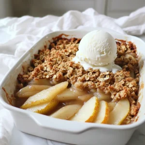 - 5 ripe pears - 1/2 cup packed brown sugar - 1 teaspoon ground cinnamon - 1/2 teaspoon ground nutmeg - 1 tablespoon fresh lemon juice - 1 cup rolled oats - 1/3 cup all-purpose flour - 1/2 cup unsalted butter - 1/4 cup chopped nuts - 1/4 teaspoon fine sea salt - Optional serving ingredients: vanilla ice cream or whipped cream Gathering fresh, ripe pears is key for this recipe. Pears add sweetness and a soft texture. Brown sugar gives richness and depth. Cinnamon and nutmeg provide warm, cozy flavors. Lemon juice brightens the dish and balances the sweetness. You will need rolled oats for the topping. They add chewiness and crunch. All-purpose flour helps bind the topping together. Unsalted butter adds richness and moisture. Chopped nuts bring a lovely crunch. I suggest walnuts or pecans for their unique flavor. Lastly, fine sea salt enhances all the sweet notes. Do not skip the optional vanilla ice cream or whipped cream. They add a creamy contrast to the warm crisp. This dessert is best served fresh from the oven. Enjoy the warm sweetness of the spiced pear crisp! Preheating your oven to 350°F (175°C) is key. A hot oven helps cook the fruits evenly. It also gives the topping that nice crunch. This step sets you up for success. Grab a large bowl. Add the sliced pears, brown sugar, cinnamon, nutmeg, and lemon juice. Toss gently until the pears are covered in spices. The lemon juice adds brightness and helps the sugar stick. This mix deepens the flavor and makes each bite delightful. Next, take the seasoned pear mix and pour it into a greased 9-inch baking dish. Spread the pears evenly. In another bowl, mix the oats, flour, melted butter, nuts, and salt. Stir until it looks crumbly. This topping gives a great texture on top of the soft pears. Now, place your baking dish in the hot oven. Bake for 30-35 minutes. Watch for the topping to turn golden brown. The pears should bubble and become tender. This is when the crisp reaches its peak flavor. Once baked, take it out of the oven. Let it cool for about 10 minutes. This cooling time helps the crisp set. Serve it warm, maybe with some vanilla ice cream or whipped cream. The cold cream pairs perfectly with the warm crisp. Enjoy every bite! To get the best crisp, use a blend of oats and nuts. I recommend using rolled oats for their sturdy texture. Combine them with chopped walnuts or pecans for added crunch. This mix gives you a nice balance of chewiness and crunch. Make sure your topping is crumbly but not too wet. Use melted butter to help bind the oats and nuts together. This will create a golden, crunchy layer on top of the tender pears. You can easily boost the flavor of your crisp with a few simple spices. Try adding a pinch of ginger or allspice for warmth. You might also want to mix in a splash of vanilla extract with the pears for an extra layer of flavor. If you like a bit of tang, consider adding a splash of orange juice instead of lemon. This can give your dessert a bright note that pairs well with the sweet pears. To serve your spiced pear crisp, I suggest using individual bowls. This makes it feel special. Serve it warm, right from the oven. Top each bowl with a scoop of vanilla ice cream or a dollop of whipped cream. The warm crisp and cold ice cream make a perfect contrast. You can also sprinkle some extra nuts on top for a bit of flair. Enjoy every bite of this comforting dessert! {{image_4}} You can use many types of pears in this recipe. Each type brings a unique taste. Here are some great options: - Bartlett Pears: These are sweet and juicy. They soften well when baked. - Bosc Pears: They are firm and have a spicy flavor. They hold their shape during baking. - Anjou Pears: These pears are sweet and buttery. They add a lovely creaminess to the crisp. Mixing different pears can give your crisp even more flavor. Experiment to find your favorite blend. If you need a gluten-free option, you can easily swap out the flour. Here are some ideas: - Almond Flour: This adds a nutty taste and works well in the topping. - Oat Flour: Made from ground oats, this keeps the crisp texture. - Coconut Flour: This adds a hint of sweetness and absorbs moisture well. Make sure your oats are labeled gluten-free. This ensures no cross-contamination occurs. To make a vegan version of this spiced pear crisp, you can replace a few ingredients: - Butter: Use coconut oil or vegan butter instead. This will keep it rich and tasty. - Brown Sugar: Most brown sugar is vegan, but check to be sure. - Oats: Oats are naturally vegan, so you can keep them as is. This way, you can enjoy a warm dessert that fits your diet and tastes amazing! To store leftovers, let the spiced pear crisp cool to room temperature. Then, cover it tightly with plastic wrap or foil. You can also transfer it to an airtight container. Store it in the fridge for up to three days. This keeps the flavors fresh and the texture nice. When you want to enjoy the crisp again, preheat your oven to 350°F (175°C). Place the crisp in an oven-safe dish. Cover it with foil to keep it moist. Heat for about 15-20 minutes. This way, you keep the topping crunchy and the pears warm. Yes, you can freeze spiced pear crisp! Cool it completely, then wrap it tightly in plastic wrap. Place it in a freezer-safe container or bag. It will stay good for up to three months. To enjoy, thaw it in the fridge overnight. Reheat in the oven for the best texture. Yes, you can use many fruits! Apples and peaches work well. You can mix berries for a burst of flavor. Cherries also add a nice tartness. Just keep the same basic recipe. Adjust sugar based on fruit sweetness. This way, you can enjoy different tastes all year. Look for a golden brown topping. The pears should be soft and bubbly. You can poke them with a fork to check. If the fork goes in easily, it’s done. The nice smell will also tell you it’s ready. Let it cool a bit before serving to set the flavors. Vanilla ice cream is a classic choice. It adds creaminess and coolness. You can also use whipped cream for a lighter touch. A drizzle of caramel sauce can make it extra special. Serve with a cup of tea or coffee for a cozy treat. You now know how to make a tasty spiced pear crisp. Start with ripe pears, brown sugar, and spices. Preheat your oven and mix the ingredients well. We explored tips for texture and flavor, plus variations for gluten-free and vegan options. Remember to cool your crisp before serving for the best taste. This dessert is not only easy but also great for sharing. Enjoy your baking and impress your friends with this delightful treat!