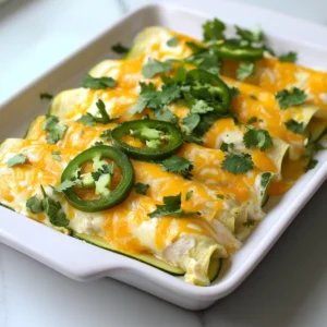 - 2 cups cooked chicken, shredded - 6 large zucchinis, used as tortillas - 1 cup cream cheese, softened - 1 cup Greek yogurt - 1 cup shredded Monterey Jack cheese, divided I love using shredded chicken for its flavor and ease. You can use any cooked chicken. Zucchini is my go-to for low-carb tortillas. They create a great texture, and you can enjoy all the fun of enchiladas without the extra carbs. The cream cheese and Greek yogurt add creaminess and tang. I always use Monterey Jack cheese for its meltiness and mild flavor. - 1 packet low-sodium taco seasoning - 1 small onion, finely chopped - 2 cloves garlic, minced I use low-sodium taco seasoning for a big flavor punch. It brings warmth and spice without being too salty. Onions and garlic add depth to the filling. Sauté them until they are soft and fragrant to make the whole dish shine. - Fresh cilantro, for garnish - Sliced jalapeños, optional for serving Fresh cilantro adds a burst of freshness. It brightens the dish and makes it look pretty. If you like heat, add sliced jalapeños. They bring a nice kick and enhance the flavors of the enchiladas. {{ingredient_image_2}} - Preheating the Oven First, preheat your oven to 350°F (175°C). This step helps cook the enchiladas evenly. - Preparing Zucchini Strips Use a vegetable peeler to slice the zucchinis. Make long strips, about 1/4 inch thick. These strips will act as your tortillas. Set the strips aside for later. - Sautéing Onions and Garlic In a large skillet, heat one tablespoon of olive oil over medium heat. Add one small, finely chopped onion and two minced garlic cloves. Cook them for about 3-4 minutes until the onion turns soft and clear. - Mixing the Filling Ingredients In a mixing bowl, combine 2 cups of shredded chicken, 1 cup of softened cream cheese, half of the shredded Monterey Jack cheese, 1 cup of Greek yogurt, and one packet of low-sodium taco seasoning. Add a pinch of salt and pepper. Stir well until everything blends together. - Rolling Zucchini Enchiladas Take one zucchini strip and place a spoonful of the chicken filling at one end. Roll the zucchini tightly, making sure the filling stays inside. Repeat this with all the strips until you have a plate full of rolled enchiladas. - Creating and Adding Cheese Sauce In a small saucepan, warm 1 cup of chicken broth over low to medium heat. Gradually stir in the remaining Monterey Jack cheese. This will melt and turn into a creamy sauce. Pour this cheese sauce over the rolled enchiladas in a greased baking dish. - Baking Process Cover the baking dish with foil and place it in the oven. Bake for 25 minutes. After that, remove the foil and bake for another 10 minutes. The enchiladas should be bubbly and golden when done. How to Slice Zucchini Effectively To make great zucchini tortillas, use a vegetable peeler. This tool gives you thin, long strips. Aim for about 1/4 inch thick. If you slice them too thick, they may not roll well. Thin strips cook better and hold the filling nicely. Preventing Excess Moisture Zucchini has a lot of water. To keep your tortillas from getting soggy, sprinkle salt on the strips. Let them sit for about 10 minutes. This helps draw out moisture. After that, pat them dry with a paper towel. This step keeps your enchiladas firm and tasty. Adding Extra Spices While taco seasoning adds great flavor, you can boost it. Try adding cumin or smoked paprika. A pinch of chili powder can add warmth. Mix these spices into the chicken filling for a deeper taste. Experiment until you find your perfect blend. Using Fresh Herbs for Garnishing Fresh herbs make your dish pop. I love using cilantro on top of the enchiladas. It adds a bright flavor. You could also use green onions for a mild kick. Just sprinkle them on right before serving to keep them fresh. Best Accompaniments These enchiladas pair well with a fresh salad. A simple side of avocado slices or guacamole adds creaminess. If you like heat, add sliced jalapeños. They give a nice kick and contrast the creamy filling. Presentation Tips To serve, place the enchiladas on a large plate. Drizzle the cheese sauce over the top. Garnish with cilantro and jalapeños. For a fun touch, add a dollop of Greek yogurt on the side. This makes your dish look appealing and inviting. Pro Tips Perfect Zucchini Strips: When slicing zucchinis, aim for even thickness to ensure they cook uniformly and maintain their shape while rolling. Flavor Boost: For extra flavor, consider adding chopped green chiles or diced bell peppers into the chicken filling mixture. Cheese Variation: Experiment with different cheeses like pepper jack or cheddar to add unique flavors to your enchiladas. Make Ahead: You can prepare the enchiladas ahead of time and refrigerate them before baking. Just add a few extra minutes to the baking time. {{image_4}} You can easily make these enchiladas fit your diet. For gluten-free options, ensure your taco seasoning has no gluten. Zucchini is naturally gluten-free, so you are good to go! If you need a dairy-free version, swap the cream cheese and cheese with dairy-free alternatives. Look for nut-based cream cheese and vegan cheese to keep it creamy. Feel free to change the protein. You can use turkey, beef, or even beans for a plant-based option. Each choice will give the dish a unique flavor. Also, consider using other veggies for your "tortillas." Thinly sliced bell peppers or cabbage can add a fun twist. Want to spice things up? Add some diced jalapeños or hot sauce to your filling. If you love bold flavors, try mixing in chipotle peppers for a smoky taste. For a creamy sauce, stick with the cheese sauce. If you prefer a lighter option, use a simple tomato-based sauce instead. Each sauce brings a new vibe to your enchiladas! For the best taste, store your enchiladas in the fridge. Place them in an airtight container. They will stay fresh for about 3 to 5 days. Make sure to let them cool down before sealing. This helps keep the flavors intact. If you want to keep them longer, consider freezing. To freeze the enchiladas, wrap them tightly in plastic wrap. Then, place them in a freezer bag or container. They can last for up to 3 months in the freezer. When you're ready to eat, just take them out and let them thaw in the fridge overnight. To reheat your enchiladas, the oven is the best choice. Preheat it to 350°F (175°C). Place the enchiladas in a baking dish, cover with foil, and heat for about 20 minutes. This method keeps them warm and prevents drying out. You can also use the microwave, but keep an eye on them to avoid overcooking. Enjoy your meal again! Yes, you can! If you want to try something different, consider using eggplant or bell peppers. Both can act as great wrappers. Slice them thinly to keep the rolls easy. Just remember to cook them a bit before rolling. This helps soften them for better flavor. To spice things up, add diced jalapeños to the filling. You can also mix in some cayenne pepper or hot sauce for heat. Another option is to top the enchiladas with a spicy salsa before serving. Adjust to your taste for the perfect kick! These enchiladas pair well with a fresh salad or some steamed veggies. You can also serve them with a side of guacamole or extra Greek yogurt. If you like crunch, try tortilla chips with salsa. Each option adds a tasty twist to the meal. To reheat, use your oven for the best results. Set it to 350°F (175°C). Place the enchiladas in a baking dish and cover with foil. Heat for about 15-20 minutes, or until warmed through. You can also use a microwave, but the oven keeps them crisp. You can make delicious low-carb white chicken enchiladas with simple ingredients. We covered main ingredients like shredded chicken and zucchini tortillas, along with seasonings for flavor. I shared step-by-step details on preparation, cooking, and baking. Tips like using fresh herbs and customizing for diets are key. Finally, I discussed storage and reheating options. Enjoy these enchiladas as a tasty meal that fits your needs! Your taste buds will appreciate it.