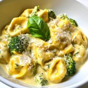 - 2 cups cheese tortellini (fresh or frozen) - 1 cup cooked chicken, shredded or diced - 2 cups broccoli florets - 1 cup heavy cream - 1 cup chicken broth - 1 tablespoon olive oil - 1 teaspoon garlic powder - 1 teaspoon onion powder - Salt and pepper to taste - 1/2 cup grated Parmesan cheese - Fresh basil leaves for garnish When picking fresh ingredients, look for vibrant colors. Choose broccoli with tight florets. It should feel firm, not soft. Check tortellini for any signs of freezer burn if using frozen. Always opt for heavy cream that has no lumps. Fresh chicken should have no odor and a bright color. For basil, select leaves that are bright green and fragrant. You can swap heavy cream with coconut milk for a dairy-free option. Use gluten-free tortellini if you have a gluten allergy. If you can't have chicken, you can use tofu or chickpeas instead. For a nut-free version, ensure your broth is free of nuts. Adjust seasonings to your taste or dietary needs. {{ingredient_image_2}} First, fill a large pot with water and add salt. Turn the heat up high to bring it to a boil. Once the water boils, add 2 cups of broccoli florets. Cook for 3 minutes. You want them to be bright green and tender-crisp. Use a slotted spoon to take the broccoli out and set it in a bowl. In the same pot, add 2 cups of cheese tortellini. Follow the package instructions for cooking time, usually 3 to 5 minutes. Once they are done, drain the tortellini and add them to the bowl with the broccoli. Grab a large skillet and heat 1 tablespoon of olive oil over medium heat. Pour in 1 cup of heavy cream and 1 cup of chicken broth. Stir them together and bring the mixture to a gentle simmer. This is where the magic starts! Next, add 1 teaspoon of garlic powder, 1 teaspoon of onion powder, and salt and pepper to taste into the skillet. Stir well for 2 to 3 minutes. Then, gently fold in 1 cup of cooked chicken, the tortellini, and the broccoli. Toss everything together carefully. Make sure each piece is coated with the creamy sauce. Once combined, remove the skillet from the heat. Stir in 1/2 cup of grated Parmesan cheese until it melts and the sauce is smooth. Spoon the creamy chicken tortellini into serving bowls. For a nice touch, garnish with fresh basil leaves. This adds color and flavor. Enjoy your meal! To make the sauce super creamy, use heavy cream. It adds rich flavor and texture. Also, mix in grated Parmesan cheese at the end. This cheese melts perfectly and thickens the sauce. For an extra touch, allow the sauce to simmer gently. This helps the flavors blend well. Stir often to keep the sauce smooth. Cooking time can vary based on the type of tortellini. Fresh tortellini cooks faster, about 3-4 minutes. Frozen tortellini usually needs 5-7 minutes. Always check the package for exact times. Overcooking can make tortellini mushy. Test a piece to ensure it’s al dente, or firm to the bite. To boost flavor, consider adding fresh herbs. Basil or parsley works great. You can also use a splash of lemon juice. It adds brightness to the dish. For spice lovers, sprinkle in some red pepper flakes. This will give your dish a nice kick. Lastly, try sautéing some onions and garlic in the olive oil before adding the cream. This builds a deep, rich flavor base. Pro Tips Use Fresh Ingredients: For the best flavor and texture, opt for fresh tortellini and broccoli when possible. Fresh ingredients can elevate the dish significantly. Adjust Creaminess: If you prefer a lighter sauce, replace half of the heavy cream with additional chicken broth. This will maintain flavor while reducing richness. Add Variety: Feel free to mix in other vegetables like spinach or bell peppers for added color and nutrition. Just adjust the cooking time accordingly. Leftovers Storage: Store any leftovers in an airtight container in the fridge for up to 3 days. Reheat gently on the stove, adding a splash of broth or cream to loosen the sauce. {{image_4}} You can add more veggies to this dish. Try adding spinach or bell peppers. They cook quickly and blend well with the creamy sauce. Zucchini also works great. Just slice it thin and add it with the broccoli. This boosts vitamins and fiber without changing the taste. If you want to switch up the protein, try shrimp or turkey. Both add a nice twist. For a vegetarian option, use chickpeas or lentils. They give a hearty feel and pack in protein. Adjust cooking times to ensure everything is cooked just right. To make this dish gluten-free, use gluten-free tortellini. Many brands offer great options. For a dairy-free version, swap heavy cream with coconut milk or a nut-based cream. Nutritional yeast can replace Parmesan cheese, giving a cheesy flavor without dairy. These swaps keep the meal rich and tasty while meeting dietary needs. To keep your creamy chicken tortellini fresh, store it in an airtight container. Let it cool to room temperature first. Then, cover and place it in the fridge. This dish lasts up to three days. Make sure to label the container with the date to track freshness. When you're ready to enjoy leftovers, reheat gently. Place the tortellini in a skillet over low heat. Add a splash of chicken broth or cream to help it warm evenly. Stir often to prevent sticking. You can also use the microwave; heat in short bursts, stirring in between. If you want to save some for later, freezing works well. Place the cooled dish in a freezer-safe container. Make sure to leave some space at the top. Cover tightly and label it with the date. This way, the creamy chicken tortellini can last for up to three months in the freezer. To reheat, let it thaw in the fridge overnight, then warm as described above. Yes, you can use frozen tortellini. Just cook it according to the package directions. Frozen tortellini cooks well and saves time. It tastes just as good as fresh. To add spice, try these options: - Add red pepper flakes to the sauce. - Mix in diced jalapeños with the chicken. - Use a spicy chicken broth for an extra kick. These options let you control the heat level. You can pair this dish with: - A fresh green salad. - Garlic bread or breadsticks. - Roasted vegetables for added flavor. These sides complement the creamy taste and make your meal balanced. The creamy chicken tortellini lasts about three to four days in the fridge. Store it in an airtight container. Make sure to reheat it gently to avoid curdling the sauce. This blog post covered all the key steps to make creamy chicken tortellini. We looked at ingredients, cooking methods, and tips to enhance flavor. You learned how to store leftovers and reheat them perfectly. Plus, you found ways to adjust ingredients for allergies and diets. I hope these insights help you create a delicious dish that everyone loves. With the right ingredients and techniques, you'll impress your family and friends. Now, it's time to enjoy your cooking adventure!