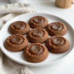 - 2 1/4 cups all-purpose flour - 2 teaspoons ground ginger - 1 teaspoon ground cinnamon - 1/2 teaspoon ground cloves - 1 teaspoon baking soda - 1/4 teaspoon salt - 3/4 cup unsalted butter, softened - 1/2 cup granulated sugar - 1/2 cup brown sugar - 1 large egg - 1/4 cup unsulfured molasses - 1 teaspoon pure vanilla extract - Extra granulated sugar for rolling You can switch butter for coconut oil or margarine. This keeps the cookies moist. For vegan cookies, use a flax egg instead of a regular egg. Just mix one tablespoon of flaxseed meal with three tablespoons of water. Let it sit until it thickens. For gluten-free options, use a gluten-free flour blend. This will change the texture but still taste good. Always check the package for best results. {{ingredient_image_2}} Whisk the dry ingredients first. In a bowl, mix 2 1/4 cups of flour, 2 teaspoons of ground ginger, 1 teaspoon of ground cinnamon, 1/2 teaspoon of ground cloves, 1 teaspoon of baking soda, and 1/4 teaspoon of salt. Make sure there are no lumps. Next, cream the butter and sugars. In a large bowl, beat 3/4 cup of softened butter with 1/2 cup of granulated sugar and 1/2 cup of packed brown sugar. Mix until light and fluffy. This will take about 2-3 minutes. Now, add the wet ingredients. Incorporate 1 large egg, 1/4 cup of unsulfured molasses, and 1 teaspoon of pure vanilla extract into the butter mixture. Mix until smooth and well combined. Chilling the dough is very important. This step helps the cookies keep their shape while baking. Cover the dough with plastic wrap and chill it in the fridge for about 30 minutes. After chilling, it’s time to shape the cookies. Use a tablespoon to scoop out portions of dough. Roll each portion into a ball with your hands. Then, roll each dough ball in extra granulated sugar until fully coated. Set your oven to 350°F (175°C) and line a baking sheet with parchment paper. This prevents sticking. Bake the cookies for 8-10 minutes. Look for the edges to be set and the centers to be slightly underbaked. They'll firm up as they cool. After baking, let the cookies sit on the baking sheet for about 5 minutes. Then, transfer them to a wire rack to cool completely. This helps them stay chewy and delicious. To get that perfect chewy texture, avoid overmixing the dough. When you mix too much, the cookies may turn out tough. Mix just until all ingredients blend together. This simple step is key for chewy cookies. Chilling the dough also plays a big role. After you mix it, wrap the dough and chill for about 30 minutes. This helps the cookies keep their shape as they bake. Chilled dough also enhances the flavors. You can add extra spices for more depth. Consider using nutmeg or allspice for a unique twist. A pinch of black pepper can also add a nice kick. These spices add warmth and richness. Using high-quality molasses is a game changer. Look for unsulfured molasses for the best flavor. The richer the molasses, the more flavor your cookies will have. This makes your cookies not just good, but truly special. For a fun presentation, arrange your cookies in a nice jar. You can also place them on a decorative platter. A light dusting of sugar gives them a lovely sparkle. Pair these cookies with a warm beverage. A cup of tea or hot cocoa complements them perfectly. The warmth of the drink enhances the spices in the cookies. It makes for a cozy treat any time of year. Pro Tips Chill the Dough: Chilling the cookie dough for at least 30 minutes helps the cookies maintain their shape and enhances the flavors. Use Fresh Spices: Ensure your ground spices are fresh for the most vibrant flavor. Older spices can lose potency over time. Don’t Overbake: To achieve chewy cookies, take them out of the oven when the edges are set but the centers are still soft. They will continue to firm up as they cool. Experiment with Mix-ins: Consider adding chocolate chips, nuts, or candied ginger for an extra twist on the classic flavor. {{image_4}} You can make your chewy ginger molasses cookies even better with add-ins. Here are two great options: - Chocolate chips: They add a wonderful richness. The dark chocolate pairs nicely with the spices. - Nuts or dried fruits: Walnuts or pecans give a crunchy texture. Dried cranberries or raisins add a sweet, chewy bite. Feel free to experiment with these mix-ins. Just keep the total amount around one cup. This way, your cookies stay soft and chewy. Want to change up the taste? Try these flavor variations: - Citrus zest: Add zest from oranges or lemons. It brightens the flavor and adds freshness. - Other spice combinations: You can mix in nutmeg or allspice for a new twist. These spices create a warm, cozy taste. These options let you customize your cookies to match your mood or the season. You can adjust the size of your cookies for different occasions: - Adjusting bake time: For larger cookies, increase the bake time by a few minutes. For smaller cookies, reduce it slightly. The edges should be set, and the centers should look soft. - Making mini cookies: Use a teaspoon to scoop smaller portions. These bite-sized treats are perfect for sharing at parties or for kids. No matter the size, these cookies will remain chewy and delicious! To keep your chewy ginger molasses cookies fresh, use an airtight container. A glass jar with a tight lid works well. You can also use a plastic container with a good seal. Store the cookies at room temperature for up to one week. They stay soft and tasty this way. If you live in a humid area, refrigerate them for longer freshness. Just remember to let them come back to room temperature before enjoying. If you want to save some cookies for later, freezing is a great option. First, let the cookies cool completely. Then, place them in a single layer on a baking sheet. Freeze them for about one hour. This will help them keep their shape. Once they are firm, transfer the cookies to a freezer bag. Remove as much air as you can before sealing. They can last for up to three months in the freezer. When you are ready to enjoy, take out a cookie or two. Let them thaw at room temperature for about 15 minutes. You can warm them up in the microwave for a few seconds if you like them warm. This brings back their chewy goodness. How do I make my cookies softer? To make your cookies softer, try these steps: - Use more brown sugar. It holds moisture well. - Do not overbake them; take them out when the edges are set. - Let the dough chill before baking. This helps keep them chewy. Can I substitute brown sugar with white sugar? You can substitute brown sugar with white sugar, but the cookies will be less chewy. Brown sugar adds moisture and a rich flavor. If you must use white sugar, consider adding a bit of molasses for extra flavor. Why are my cookies spreading too much? If your cookies spread, check these factors: - Make sure your butter is softened but not melted. - Chilling the dough helps keep cookies from spreading. - Ensure you measure your flour correctly. Too little flour can cause spreading. What type of molasses is best for this recipe? Unsulfured molasses is best for this recipe. It has a smooth taste and is less bitter. It adds a deep flavor to the cookies. Avoid using sulfured molasses, as it can alter the taste. How can I tell if my baking soda is still active? To check if your baking soda is still active, do this simple test: - Mix a teaspoon of baking soda with a bit of vinegar. - If it bubbles up, it is still good to use. If not, replace it. Fresh baking soda is key for great cookies! You now have all the tools to bake chewy ginger molasses cookies. We covered ingredients, substitutes, and step-by-step instructions. Remember to chill your dough for the best texture and flavor. Feel free to add nuts or chocolate chips for a twist. Proper storage keeps your cookies fresh for longer. Enjoy sharing your delicious treats! Happy baking!