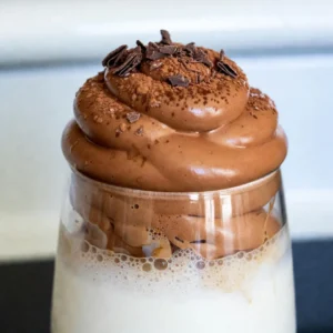 To make your Mocha Dalgona Whipped Coffee, gather these items: - 2 tablespoons instant coffee - 2 tablespoons unsweetened cocoa powder - 2 tablespoons boiling water - 2 tablespoons granulated sugar - 1 cup milk (your choice of dairy or dairy-free) - Ice cubes (optional, for iced coffee lovers) - Cocoa powder or chocolate shavings, for garnish You can swap some ingredients based on your needs: - Use decaf instant coffee if you want less caffeine. - For a vegan option, choose almond, oat, or coconut milk. - Instead of sugar, try maple syrup or agave nectar for sweetness. Using high-quality ingredients makes a big difference. Fresh instant coffee gives a rich taste. Unsweetened cocoa powder adds depth. Choose good milk for creaminess. If you use fresh cocoa powder or chocolate shavings, it boosts flavor and looks. Always try to source organic or fair-trade options when possible. This not only helps your drink but also supports farmers and the environment. {{ingredient_image_2}} 1. Start by gathering your ingredients. You need instant coffee, cocoa powder, boiling water, sugar, and milk. 2. In a medium bowl, mix 2 tablespoons of instant coffee with 2 tablespoons of unsweetened cocoa powder. 3. Add 2 tablespoons of boiling water to the mixture. 4. Next, add 2 tablespoons of granulated sugar. 5. Use an electric mixer or a hand whisk. Whip the mixture on high speed for 2-4 minutes. 6. Keep whipping until it becomes light and fluffy. It should hold its shape but still be soft. 7. Now, take a glass. Pour in 1 cup of milk. You can use hot milk or cold milk with ice cubes. 8. If you want an iced drink, fill the glass with ice first. 9. Carefully spoon the whipped coffee on top of the milk. This creates a nice layered look. 10. If you prefer, stir the whipped coffee into the milk for a blended effect. 11. Lastly, add a sprinkle of cocoa powder or chocolate shavings on top for garnish. 12. Serve your mocha Dalgona whipped coffee right away and enjoy! To get the best foam, use cold mixing bowls and utensils. Cold tools help the mixture whip faster. If using a hand whisk, be ready for a workout! It takes more time, but you can still achieve great foam. Whip until the mixture turns thick and holds peaks. This means you can turn the bowl upside down, and it won’t fall out. For a cozy drink, use hot milk and sip it slowly. For a refreshing treat, pour cold milk over ice. You can even blend the whipped coffee with the milk for a smooth drink. If you want to impress, keep the layers separate. It looks beautiful and tastes great! Enjoy your mocha Dalgona whipped coffee however you like best. One of the biggest mistakes is not using instant coffee. Regular coffee won't whip up. Another mistake is not measuring ingredients accurately. Too much liquid can ruin your foam. If you mix too slowly, you won't get enough air into your coffee. Finally, don't skip the sugar. It helps make the foam stable. Using an electric mixer is the easiest way to whip your coffee. It saves time and effort. Whipping with a hand whisk takes longer and needs more strength. If you use a whisk, make sure to whip quickly. Aim for a fluffy, thick texture. No matter your method, keep your bowl steady while mixing. To make your mocha Dalgona even better, try using strong coffee. Brew your coffee with less water for a bold taste. You can also experiment with flavored syrups. Vanilla or hazelnut can add a nice twist. Finally, try different milk options. Almond or oat milk can change the flavor and texture. Pro Tips Perfecting the Foam: Whip the coffee mixture until it forms stiff peaks, similar to whipped cream, for the best texture. Milk Variations: Experiment with different types of milk, such as oat, almond, or coconut, to find your favorite flavor pairing. Sweetness Level: Adjust the amount of sugar according to your taste preference, or use a sugar substitute for a healthier option. Garnishing Ideas: Try adding a sprinkle of cinnamon or a drizzle of caramel for an extra indulgent twist. {{image_4}} You can easily turn this drink into a refreshing iced treat. To make iced mocha Dalgona whipped coffee, follow these steps. First, brew the coffee mixture as usual. Then, fill a glass with ice cubes before adding milk. Pour the milk over the ice. Finally, spoon the whipped coffee on top. The cold milk and ice make it a perfect summer drink. Want to spice up your mocha Dalgona? You can add flavored syrups or extracts. Vanilla syrup gives a sweet twist. Caramel syrup adds a rich taste. For a minty kick, try peppermint extract. Just mix a teaspoon of the syrup or extract into your coffee mixture before whipping. This small change can make a big difference. If you prefer a dairy-free option, you have plenty of choices. Use almond milk, oat milk, or coconut milk instead of regular milk. Each type brings unique flavors. For a vegan version, ensure your sugar is vegan-friendly. This way, everyone can enjoy the mocha Dalgona whipped coffee without worry. By making these changes, you still get a delicious drink that fits your needs. If you have leftover whipped coffee, store it in an airtight container. Place it in the fridge. This keeps it fresh for later use. Avoid leaving it out at room temperature. The foam will lose its fluffiness quickly. The whipped coffee can last in the fridge for up to 3 days. However, the milk is different. If you use dairy milk, it usually lasts 5-7 days. Dairy-free milk often lasts longer, about 7-10 days. Always check the expiration date on the milk carton. You can get creative with leftover whipped coffee! Try it in smoothies or on pancakes. Swirl it into oatmeal for a tasty breakfast. It can also be used as a topping for desserts like brownies or ice cream. The options are endless! You should use instant coffee for Dalgona coffee. Instant coffee dissolves well and whips easily. It gives that rich flavor we love. Brands like Nescafé or Folgers work great. Avoid ground coffee; it won't whip into foam. Instant coffee creates that perfect texture for your drink. Yes, you can! If you skip cocoa powder, your drink will taste like plain Dalgona coffee. You can add flavored syrups or vanilla extract instead. This way, you still get a tasty drink without cocoa. Experiment with different flavors to find what you enjoy. Your whipped coffee may not be fluffy for a few reasons. First, make sure you use instant coffee. Then, check if your mixer is on high speed. Whipping time matters too; it should take 2-4 minutes. Lastly, too much water can make it dense. Adjust these factors for the perfect foam. You’ve learned how to create Dalgona coffee with the best ingredients and steps. Quality ingredients matter for taste. Follow the tips to avoid mistakes and whip perfectly. Don’t forget to try different flavors and variations to find your favorite. Store your leftovers so nothing goes to waste. I hope these ideas inspire your next coffee adventure. Enjoy crafting your perfect cup!